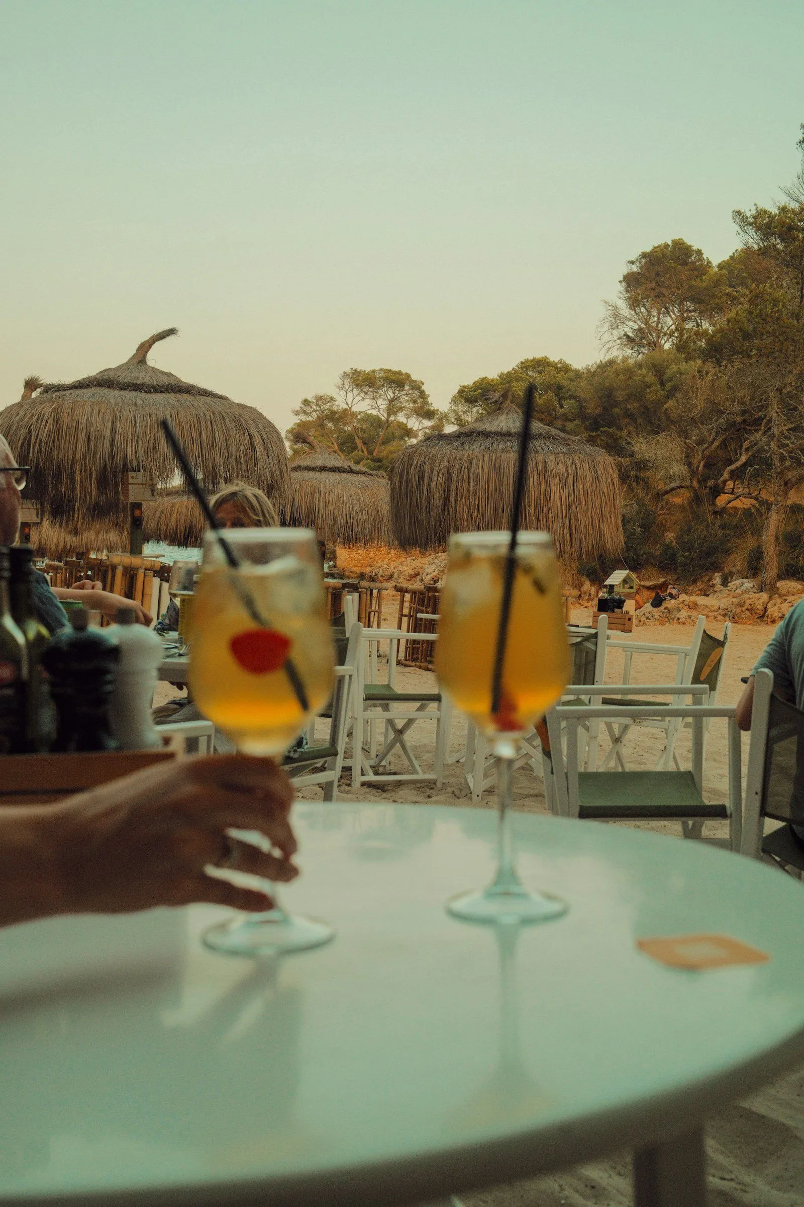 Two glasses of spritz on a café table at a beach bar